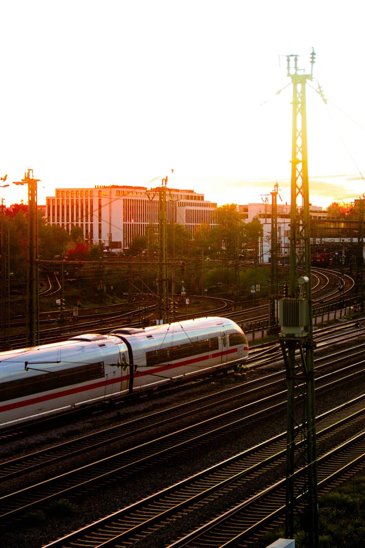 a train traveling down train tracks near a city