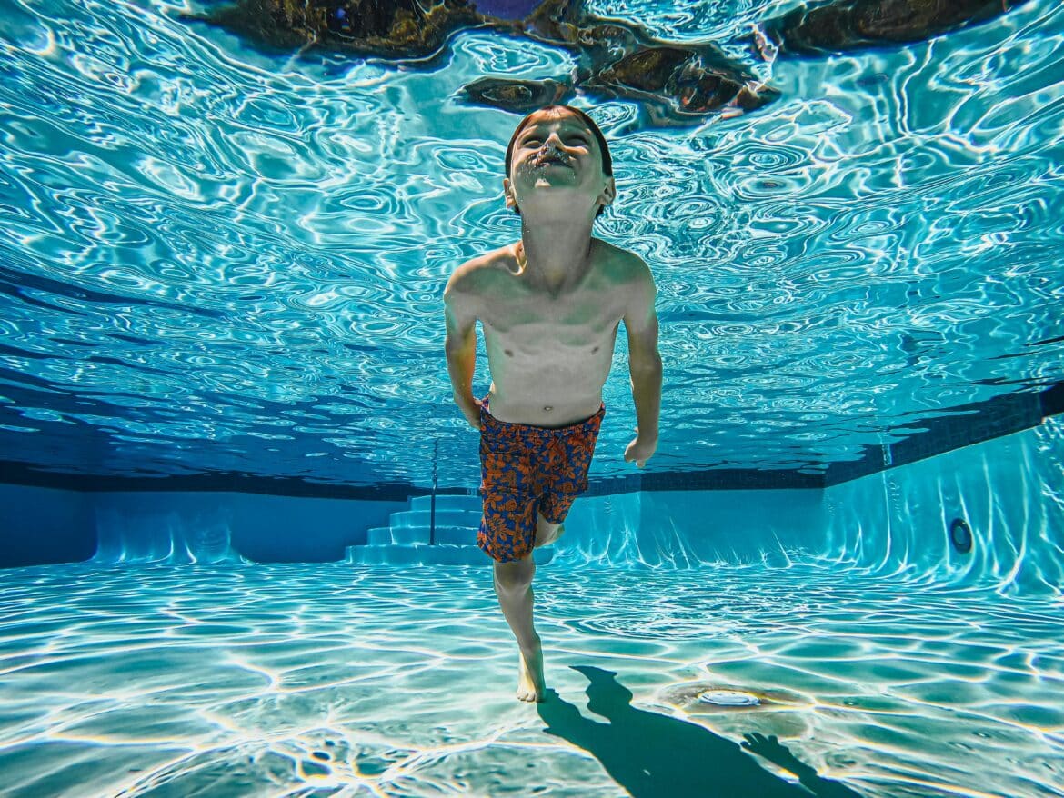 Kid swimming underwater