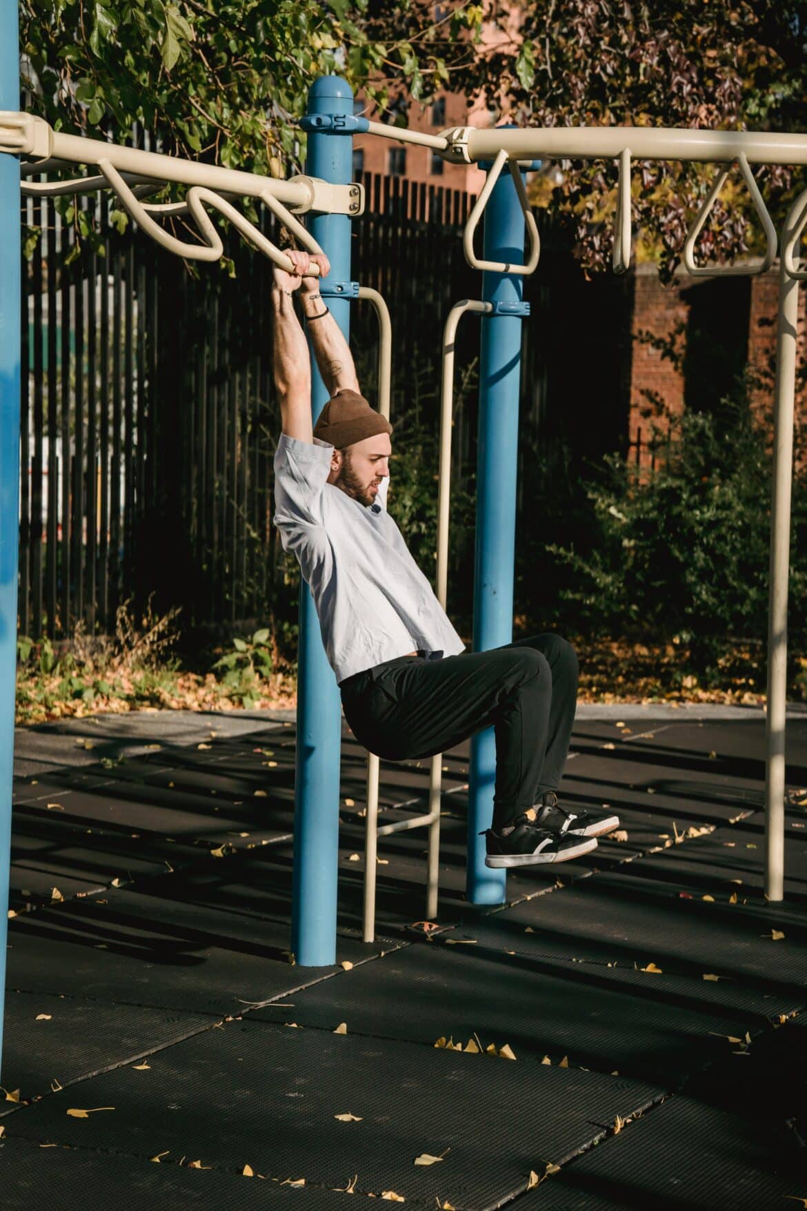Unrecognizable man swinging on turnstile in park