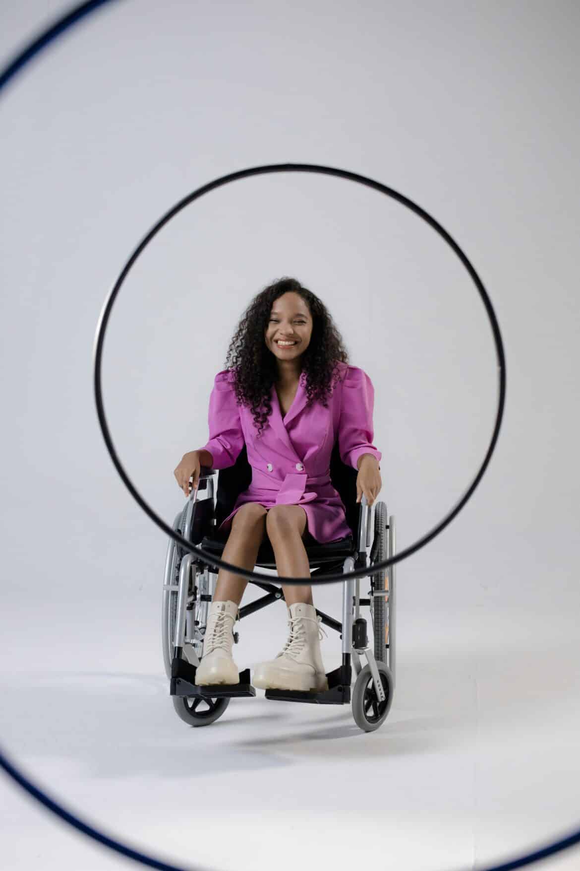 A woman on a wheelchair wearing a pink outfit