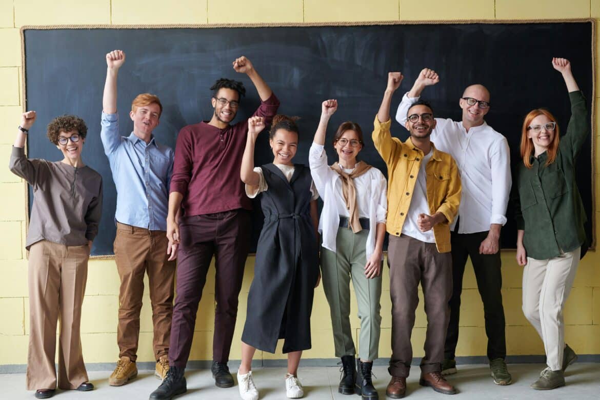 Group of people standing infront of blackboard