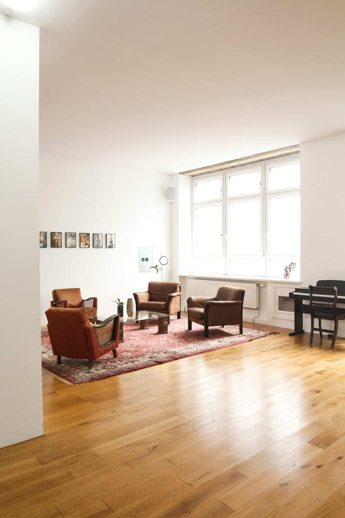 Armchairs, piano and living-room in event space in Berlin, Germany. Available for rent for your next shoot or production via beazy.co.